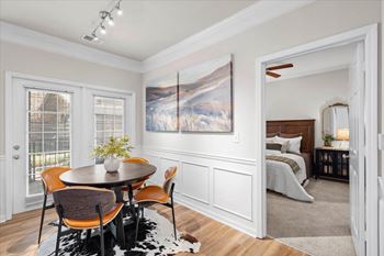 Dining room with wooden table and chairs with bedroom view